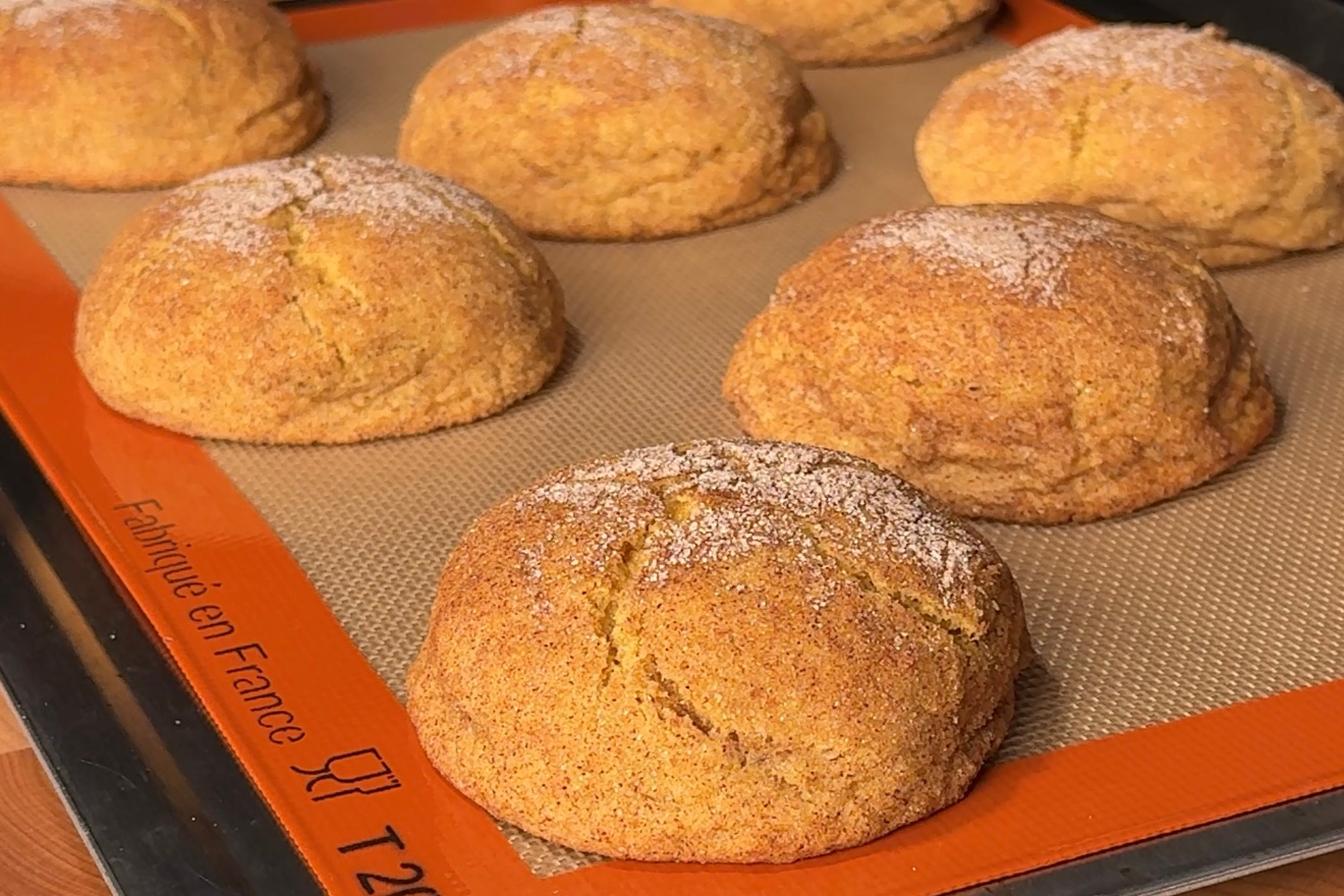 snickerdoodle cookies on a silicone mat-lined baking tray
